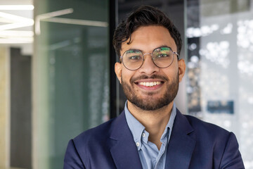 Confident young professional smiling in modern office environment