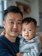 © nicole - Photograph of an Asian single father in his late 30s, sharing a moment with his son. He's dressed in comfortable yet stylish clothes, capturing a warm, familial atmosphere in an urban setting