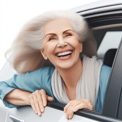 Wall Mural - Happy old woman with head out of the car window having fun Isolated on white background