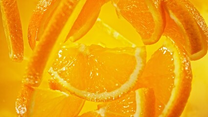 Aufkleber - Freeze Motion of Flying Orange Slices into Water, Colored Background.