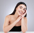 © peopleimages.com - Portrait, skincare and woman with hands by white background for beauty, happy and dermatology. Gen z, face and smile for detox, glow and shine with luxury and treatment with results in studio