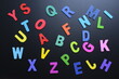 © sutichak - colorful letter alphabet on black background, object for education