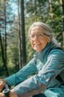 © Fotograf - A woman riding a bike through a forest, perfect for outdoor and adventure themes