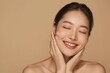 © ant - Young Asian woman touching her face with healthy skin.