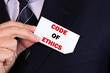 © PRO Balance - Businessman putting a card with text code of ethics in the pocket