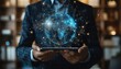 © Creative_Bringer - Businessman holding a tablet displaying a holographic globe with network connections