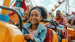 © sommersby - A group of children laughing and having fun while riding on a colorful carnival attraction