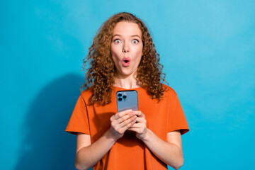 Poster - Photo of amazed girl hold use smart gadget isolated blue color background