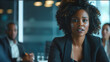© HillTract - Black businesswoman pitching ideas to colleagues in a conference room.