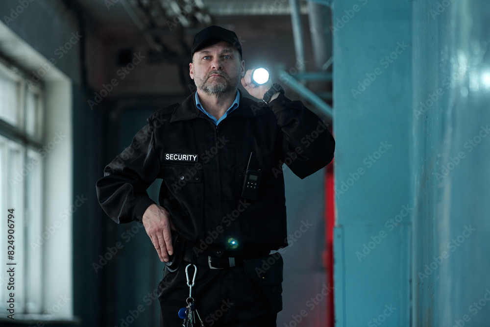 Security Move Along Mature male security guard in uniform and cap lighting forward with ...
