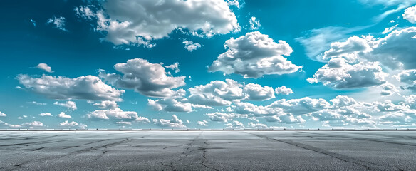 Empty smooth asphalt road and blue sky with white clouds. Road b