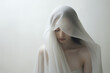 © Nuikubs - Ethereal woman draped in white fabric, embracing serenity and tranquility in a soft and minimalist setting, perfect for calm and peaceful concepts.