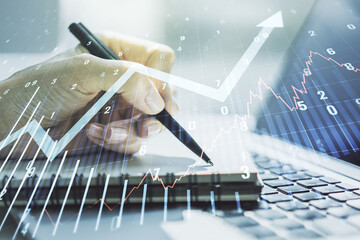 Poster - Multi exposure of abstract financial graph with upward arrow and hand writing in diary on background with laptop, financial and trading concept
