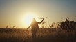 © maxximmm - girl runs across the field. concept of a happy childhood and loving family. girl runs across a field with an airplane in her hands, silhouette of a child, sunset on the lifestyle background
