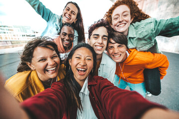 Multicultural friends taking selfie with smart mobile phone outside - Happy young people smiling together at camera - Technology and youth culture concept