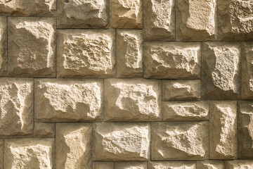 Canvas Print - Solid house stone wall of roughly hewn stone closeup as stone background