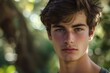© anatolir - Close-up portrait of a handsome young man with piercing eyes surrounded by soft, natural light