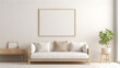 © NUSRAT ART - A Scandinavian-inspired room with a mix of light wood furniture, a white sofa, and a blank empty white frame mockup on the wall.
