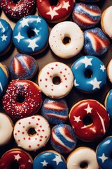 Wall Mural - A close up of many donuts with stars and stripes on them. The donuts are decorated with blue, white, and red icing