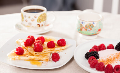 Wall Mural - Breakfast of pancakes with fresh raspberries on table