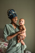 © Milles Studio/Stocksy - Happy black mother holding naked baby