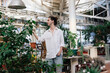 © Jovana Milanko/Stocksy - Portrait of a man enjoying his indoor garden