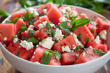 Wall Mural - there is a bowl of watermelon and feta salad with mint leaves