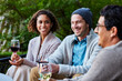 © Trinette Reed/Stocksy - Group of friends drinking wine outdoors
