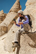 © Luis Herrera/Stocksy - Female Hiker Using Cell Phone