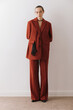 © Serge Filimonov/Stocksy - Full body fashion portrait of woman in suit