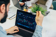 © VICTOR TORRES/Stocksy - Analyzing financial crypto data on a laptop in an office