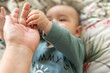 © Eloisa Ramos/Stocksy - Baby Holding mom's Finger