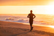 © Oleksandr Stalovierov/Stocksy - Morning run on the beach.