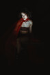 © Laura Herrera/Stocksy - Stylish queer  man in Red Accessories and Vampire Makeup