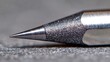 © weerasak - Close-up image of a metal pen tip on a textured surface, highlighting precision and detail in everyday writing instruments.
