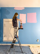 © Raymond Forbes LLC/Stocksy - Cute girl  Painting her bedroom in renovation of room in house