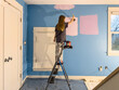 © Raymond Forbes LLC/Stocksy - Young girl diy Painting her bedroom in renovation of room