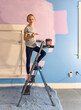 © Raymond Forbes LLC/Stocksy - Young girl Painting her bedroom in renovation of room in house