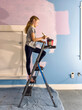 © Raymond Forbes LLC/Stocksy - Young girl Painting her bedroom in renovation of room in home