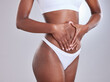 © peopleimages.com - Woman, body and hands frame on stomach for nutrition, beauty and fitness or wellness for liposuction in studio. Cosmetic tummy tuck, diet care and digestion or gut balance with model in underwear
