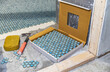© Raymond Forbes LLC/Stocksy - Tile Construction  Residential bathroom Improvement renovation hammer