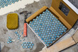 © Raymond Forbes LLC/Stocksy - Tiling Construction in Residential Home Improvement renovation hammer