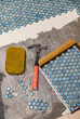 © Raymond Forbes LLC/Stocksy - Tile Construction in Residential Home Improvement renovation sponge