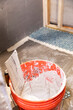 © Raymond Forbes LLC/Stocksy - Tile Construction in  Home Improvement renovation grout bucket