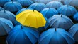 © Willard - Yellow umbrella standing out among blue umbrellas