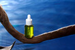 © Marc Tran/Stocksy - The collagen hydrating serum stands on driftwood over blue water