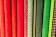 © nomad studio/Stocksy - Colorful assortment of fabric rolls
