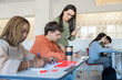 © Santi Nuñez/Stocksy - Focused Students with teacher