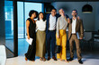 © BONNINSTUDIO/Stocksy - Group of diverse financial businesspeople stnading at workspace