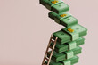 © Giada Canu/Stocksy - 3D Render of Ascending Currency Stacks with Wooden Ladder